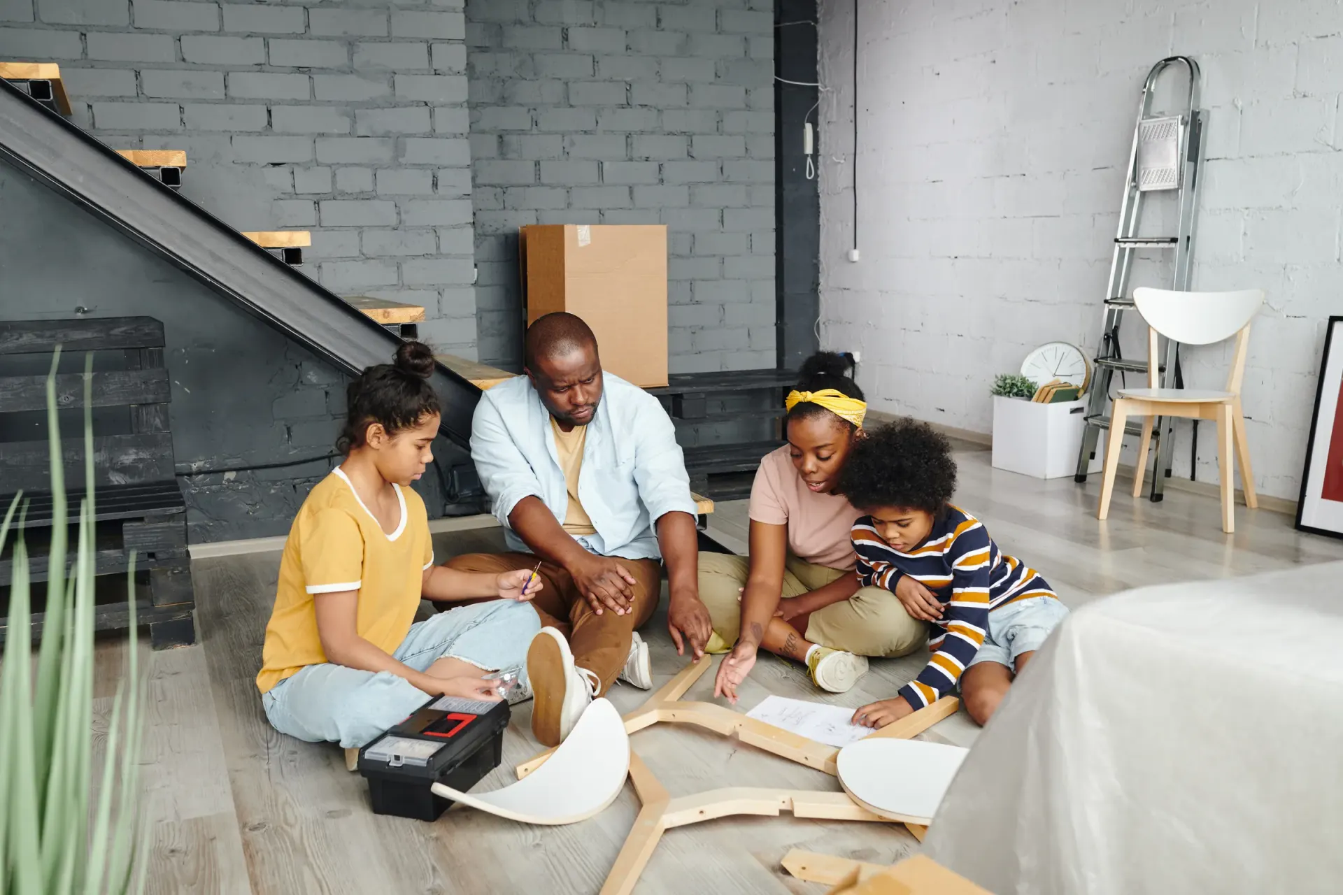 Une famille assemble un meuble dans son nouveau logement